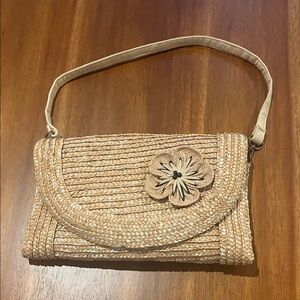Poppi Jones Woven clutch with Floral Accent.